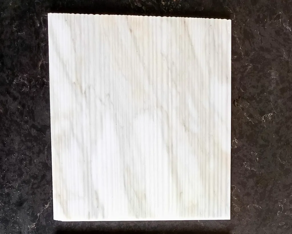 Fluted finish sample in white veined marble, machined for wall paneling