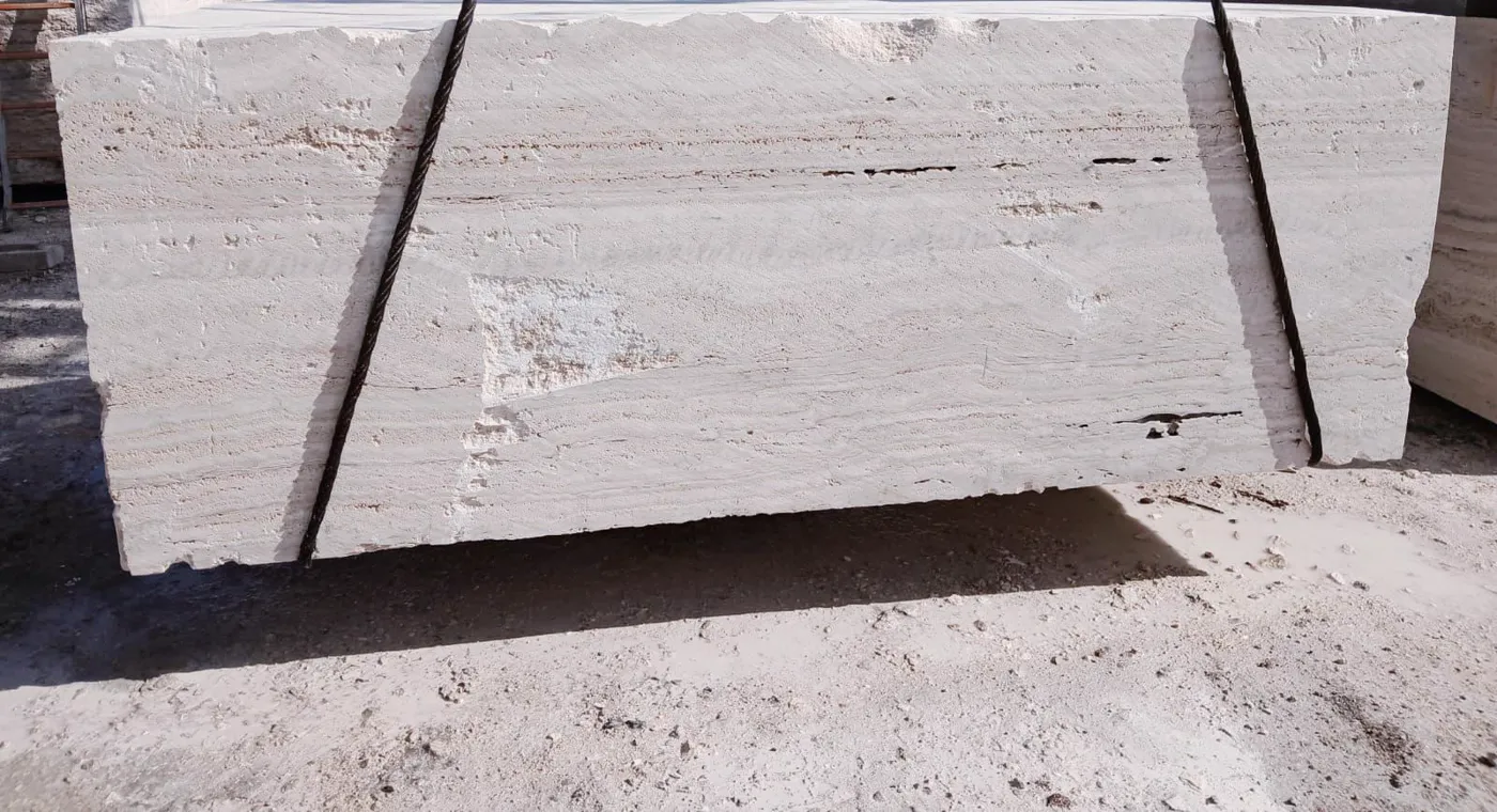 Stone block rigged with steel cables for handling in the yard before sawing