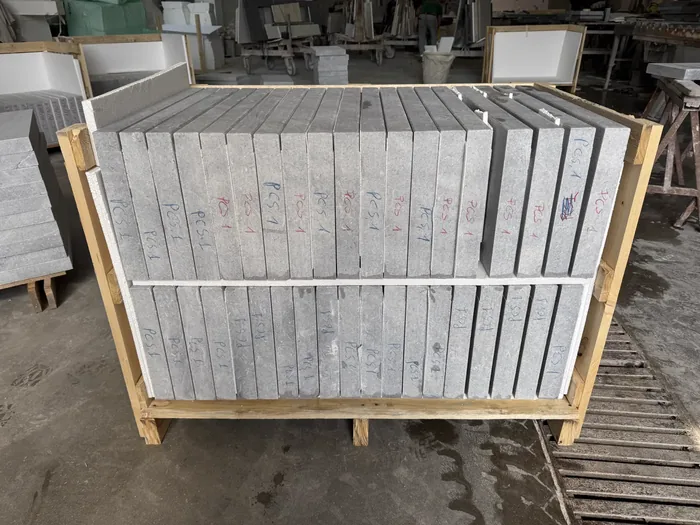 Export crate packed with stone pieces on edge, each row marked with its count