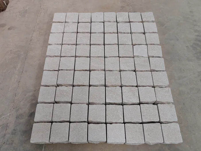 Grid of stone setts laid dry on the ground