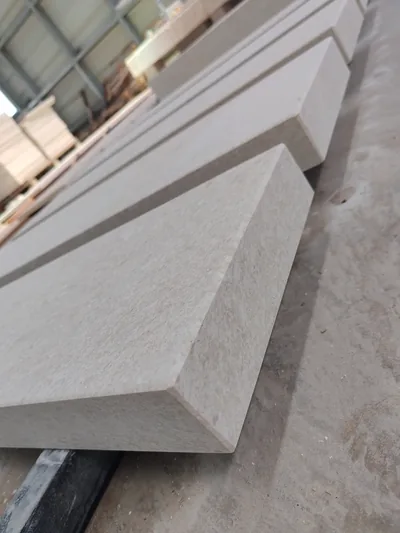 Solid stone step with an eased edge in the workshop, more steps behind