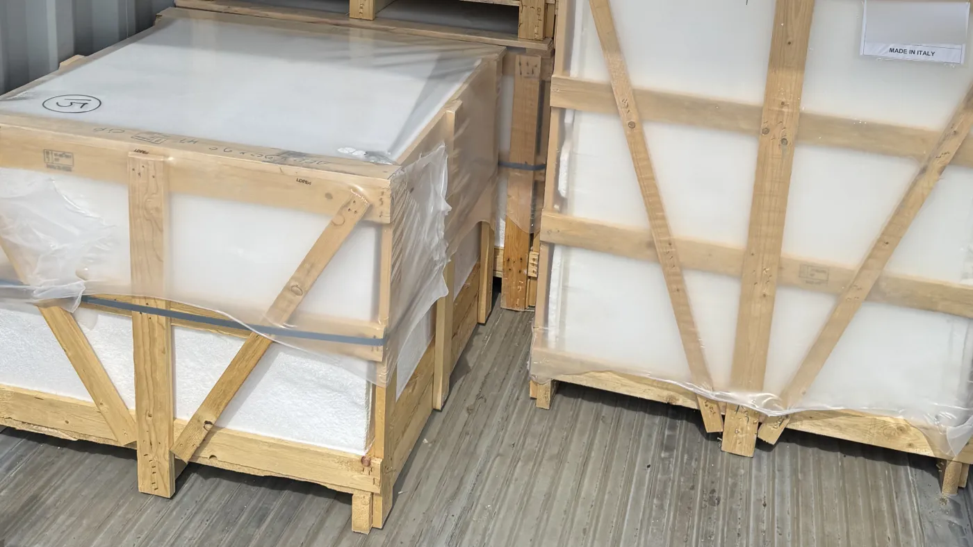 Wooden export crates braced and strapped on the floor of a shipping container