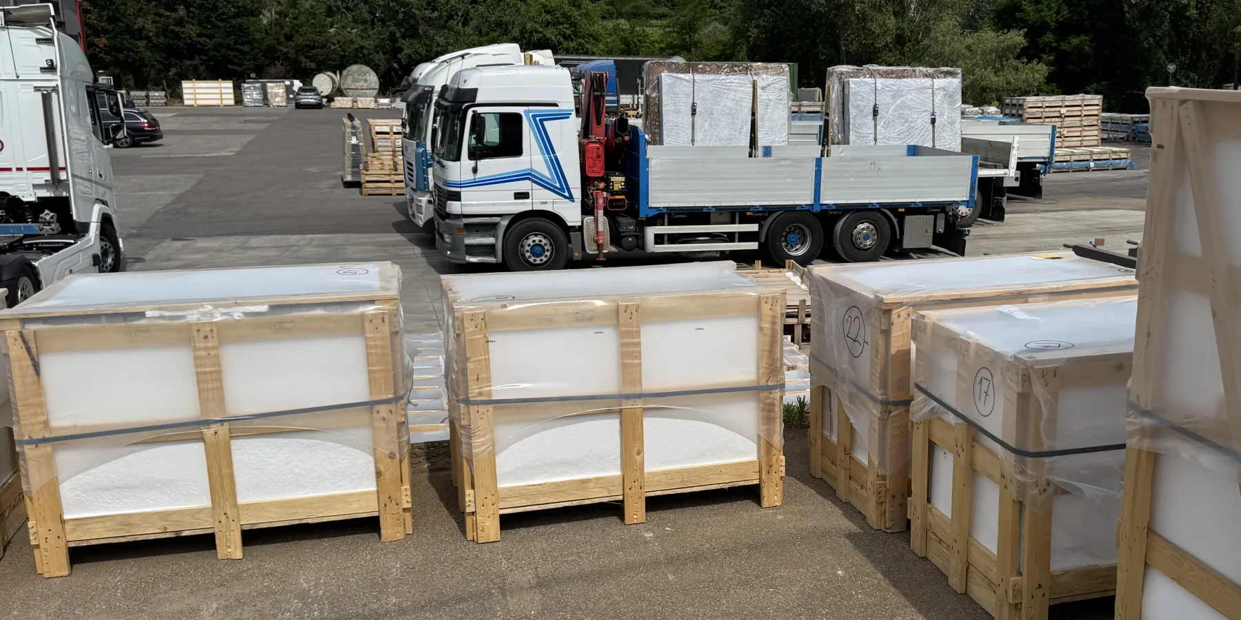 Custom export crates of grey stone staged in the loading yard