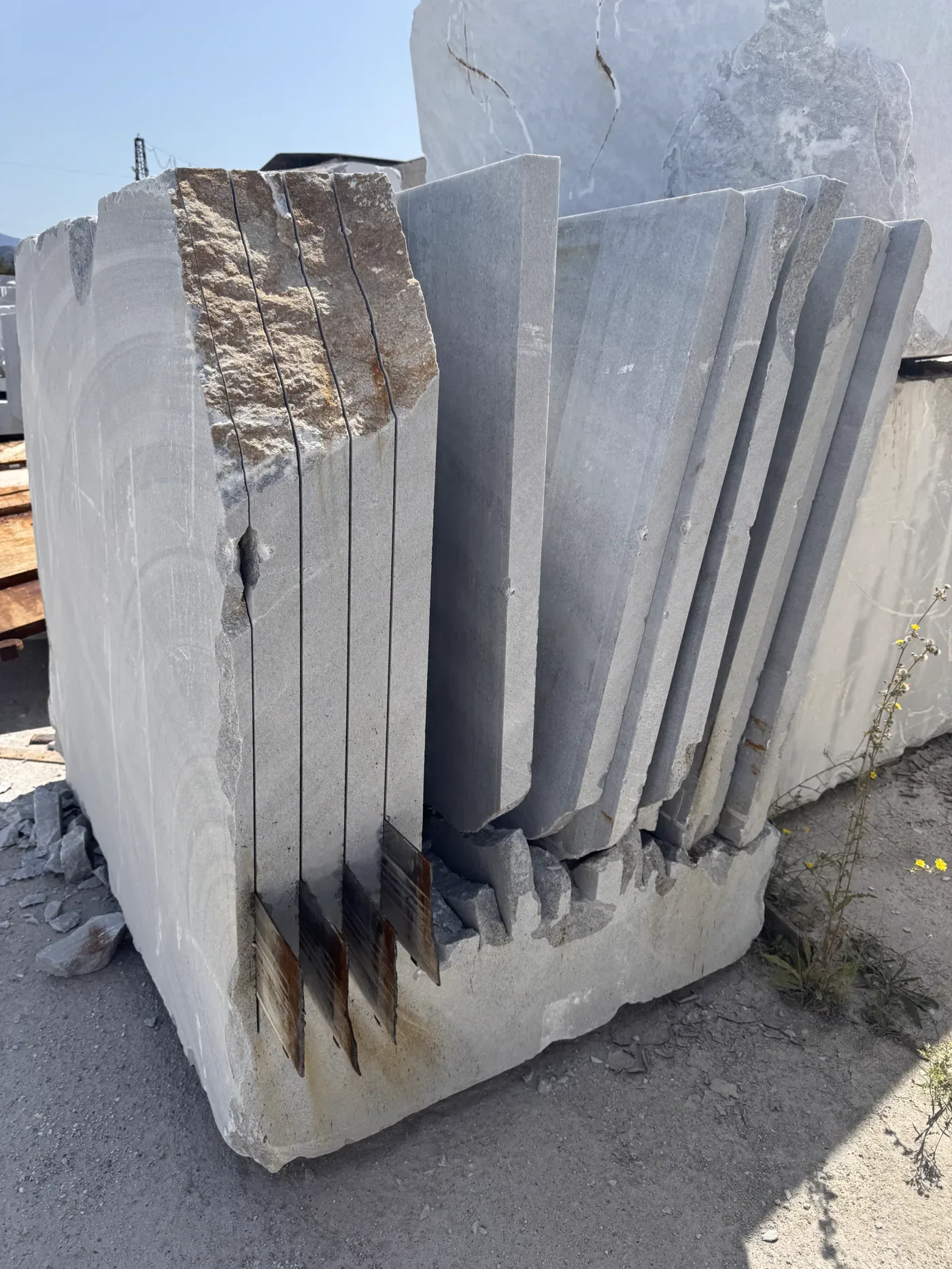 Sawn stone block with vertical slices still standing in the cut