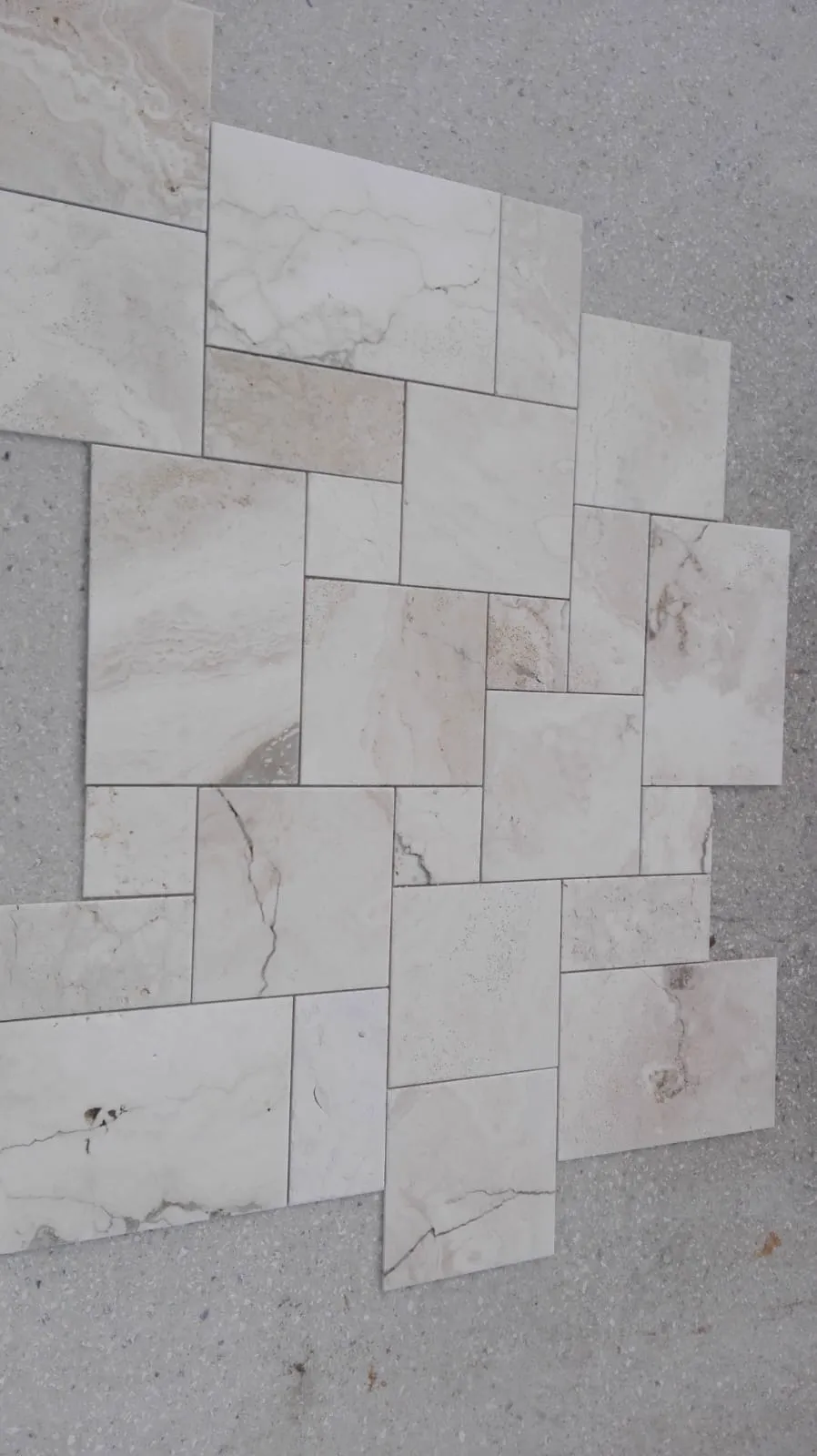 Travertine French pattern dry-laid on the floor for layout approval