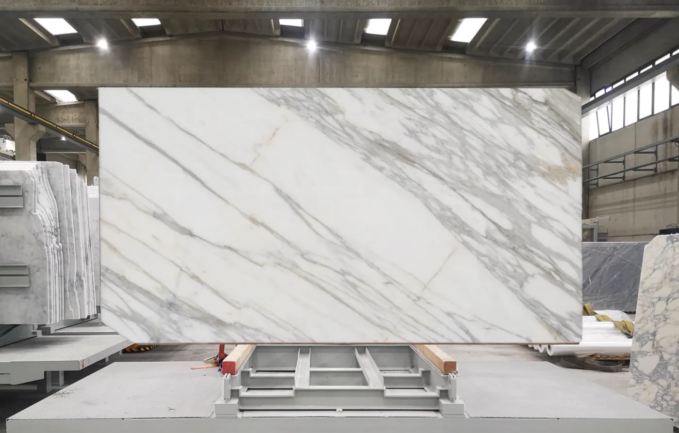 Full Calacatta marble slab on the rack, screened for vein matching