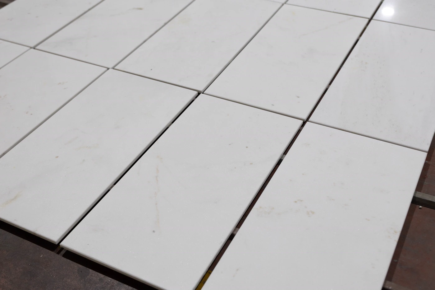 White cut-to-size tiles dry-laid for selection and caliber control